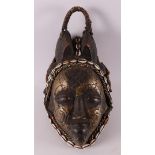 A carved wooden and brass 'Mourning mask', Punu, Gabon, Africa, 20th century