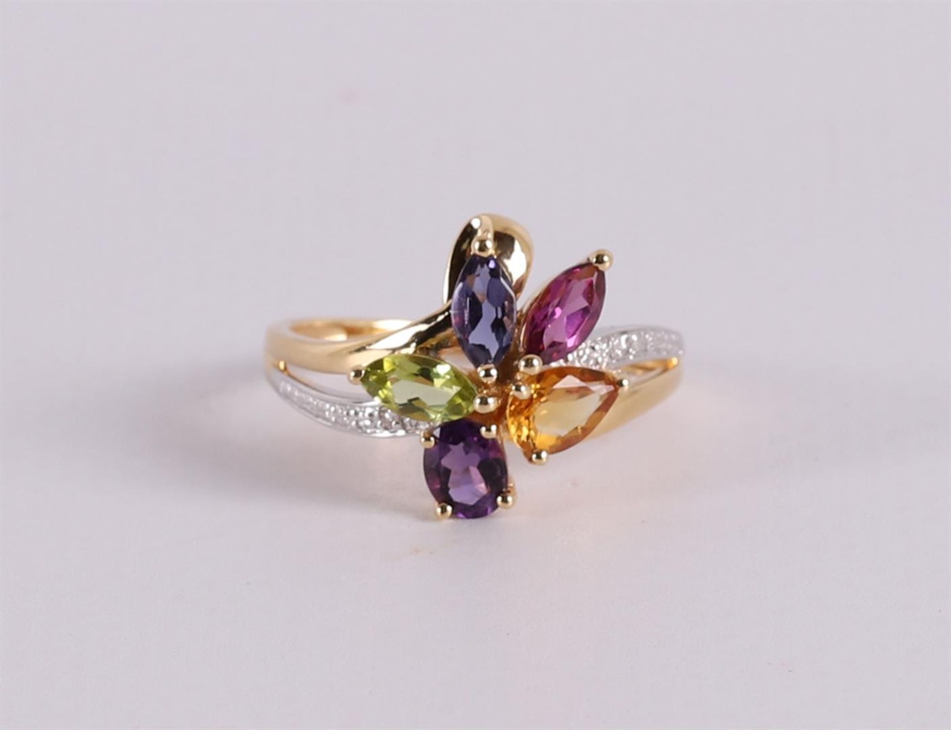 An 18 kt gold cocktail ring with various colored stones and 2 diamonds.