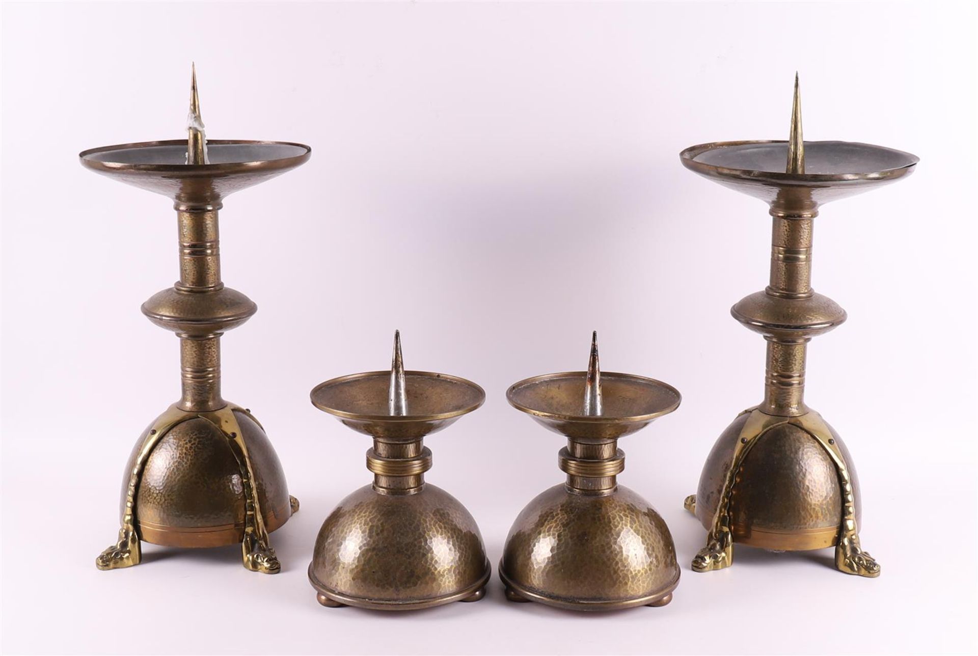 Four hammered brass Amsterdam school church candlesticks, ca. 1930.