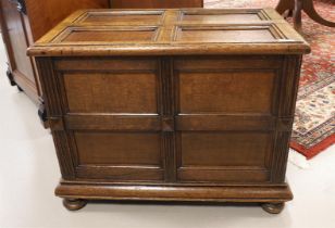 An oak chest with flap lid resting on flattened ball feet, 19th century