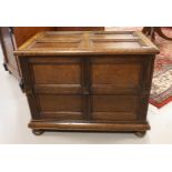 An oak chest with flap lid resting on flattened ball feet, 19th century