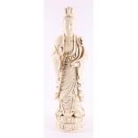 A white Chinese Kwan Yin standing on a lotus crown, China, 20th century.