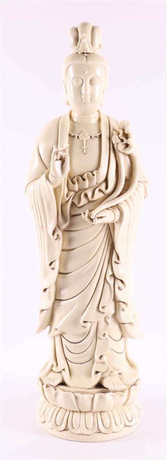 A white Chinese Kwan Yin standing on a lotus crown, China, 20th century.