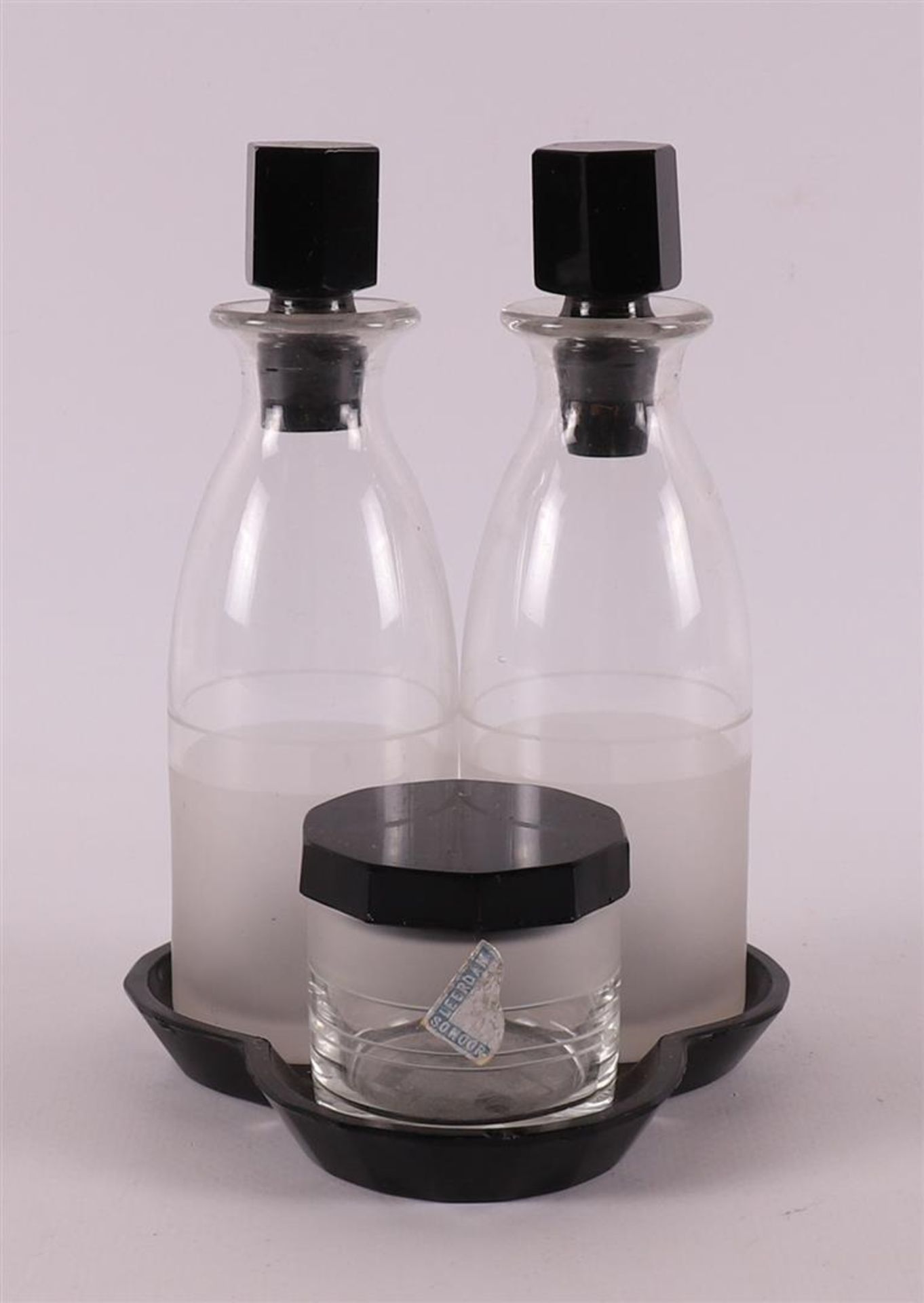 A glass and black glass oil and vinegar set on a lower tray, design: A.D.Copier