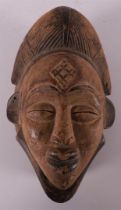 A carved wooden Punu mask, Gabon, Nigeria, Africa, 2nd half of the 20th century