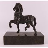 A brown patinated bronze horse on green natural stone base, 20th century.