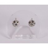 A pair of 14 kt gold stud earrings with 2 brilliant cut diamonds.