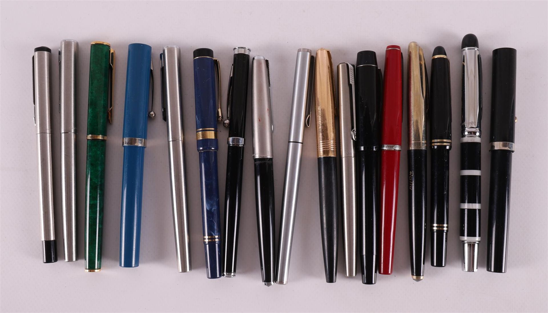 A lot of various fountain pens, including Parker and Shaeffer