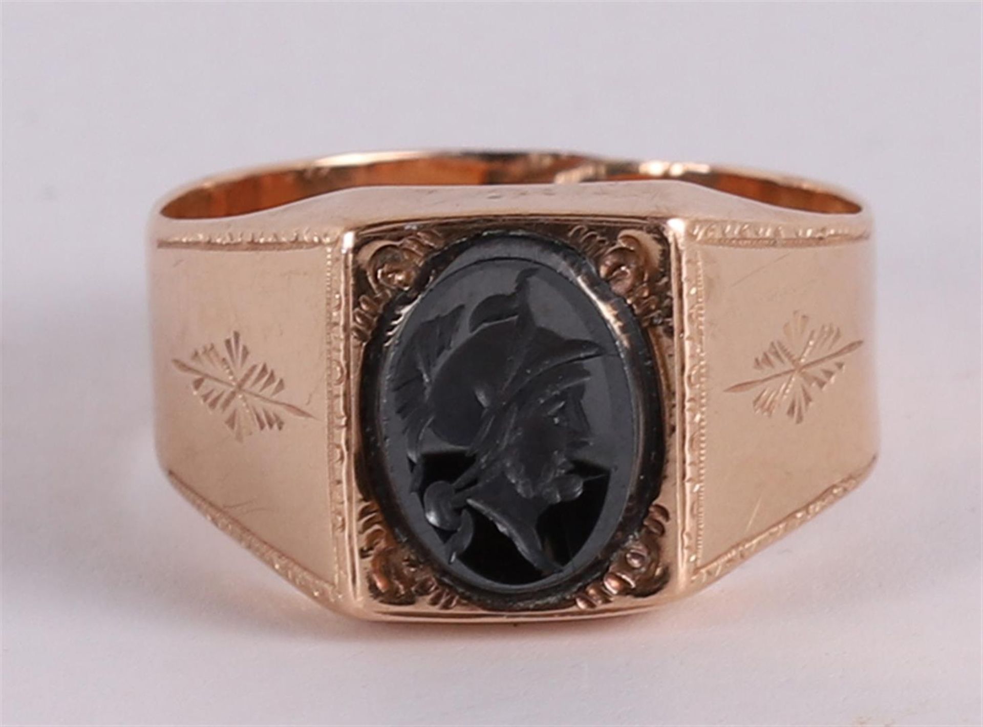 A 14 kt gold cachet ring with black onyx with a minerva head.