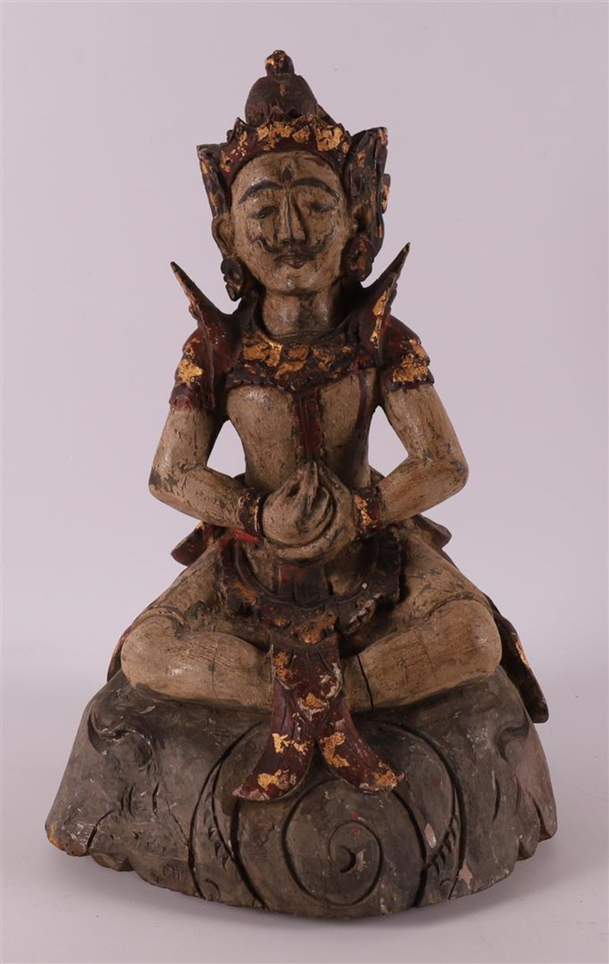 A carved wooden temple statue of a seated man, Indonesia, 19th/20th century