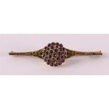 A 14 carat gold brooch set with many faceted garnets, around 1900.