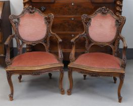 A pair of walnut armrest armchairs, neo Louis XV style, late 19th century.