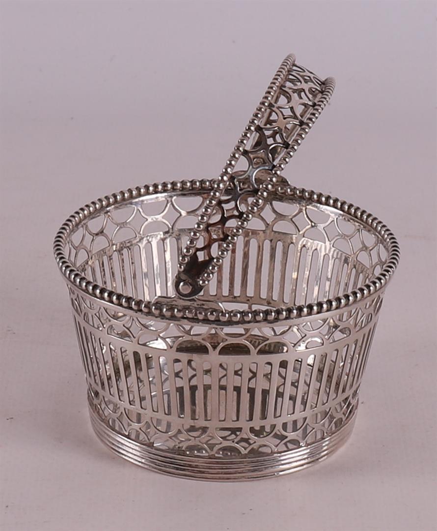 A silver openwork wool basket with pearl rim and handle, ca. 1830.