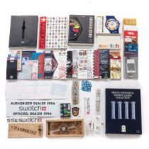 A Collection of Swatch Watches and Booklets