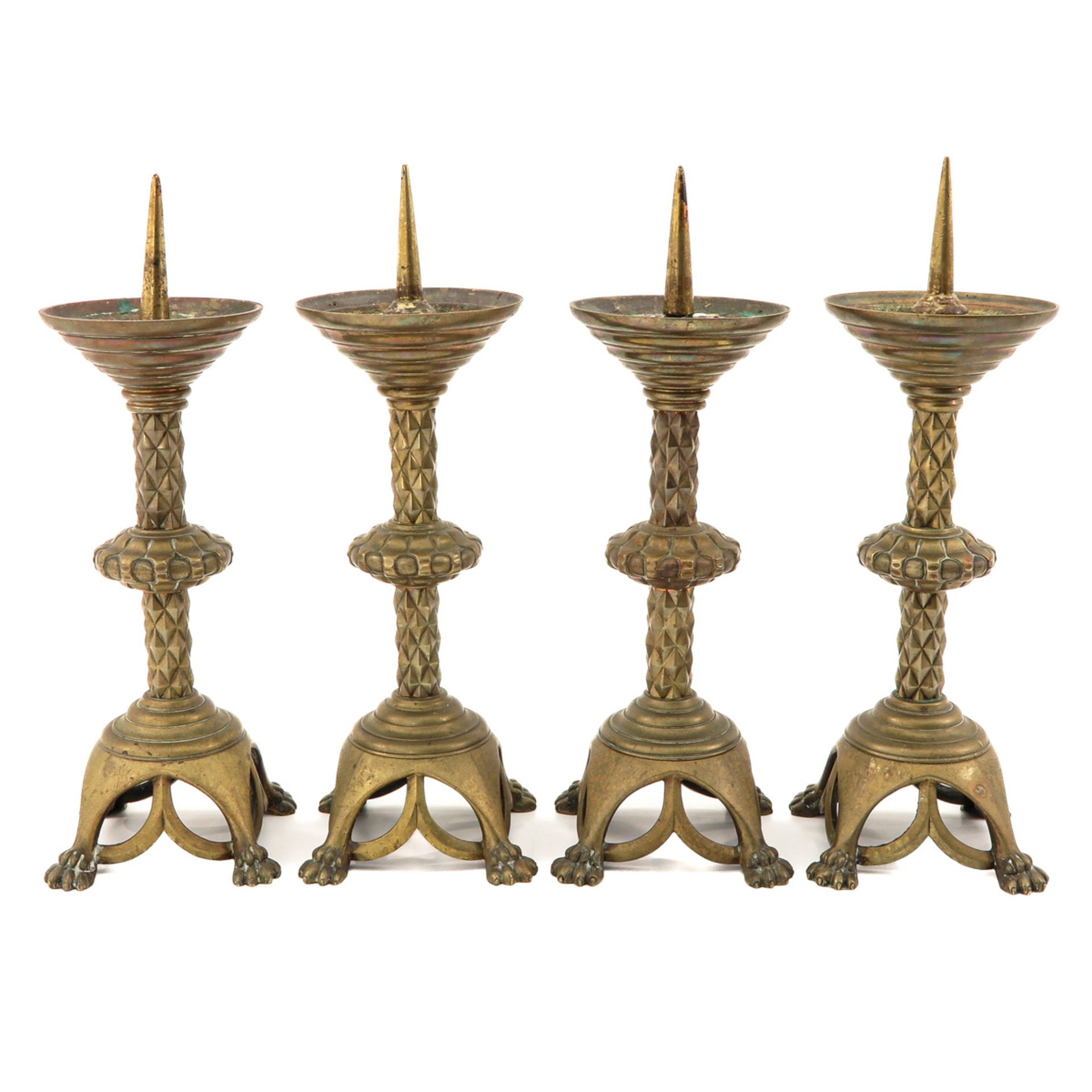 A Collection of 4 Bronze Altar Candlesticks