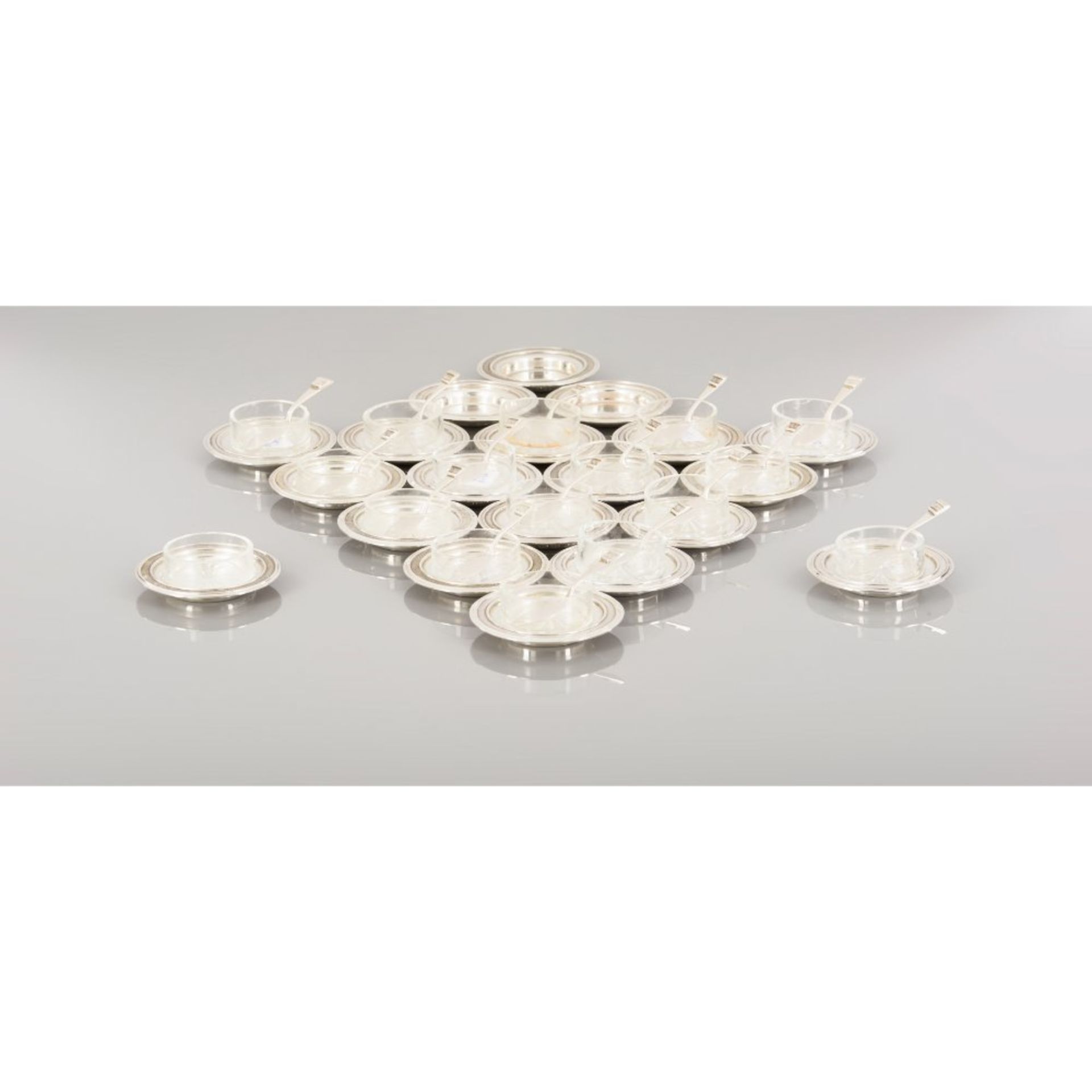 A set of twenty butter dishes