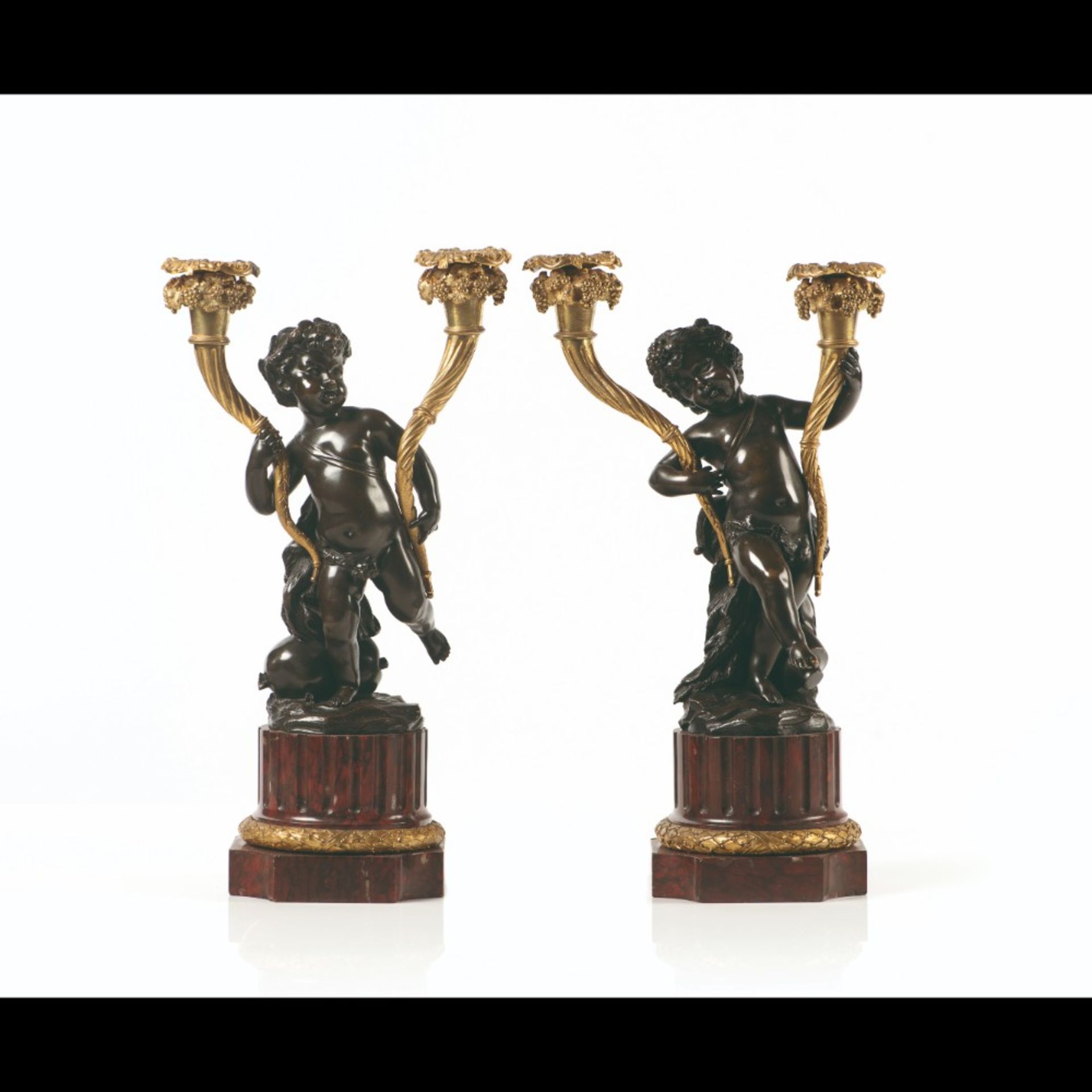  A pair of Louis XVI style two-light candelabra