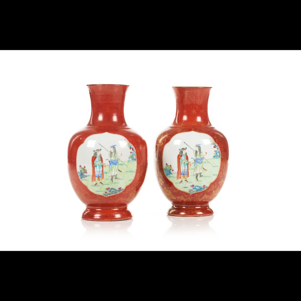  A pair of coral coloured vases
