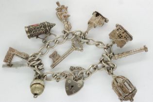 Hallmarked silver charm bracelet with padlock clasp, safety chain and ten charms, L: 18 cm, 40g.