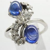 Unmarked white metal cluster ring set with sapphire cabochons and diamonds, size Q/R, 5.2g. UK P&P