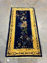 Blue ground woollen rug with asymmetric floral design, 94 x 180 cm. Not available for in-house P&P