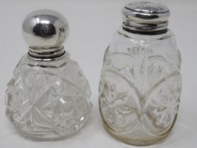 Two hallmarked silver topped cut glass bottles, largest H: 66 mm. UK P&P Group 2 (£20+VAT for the