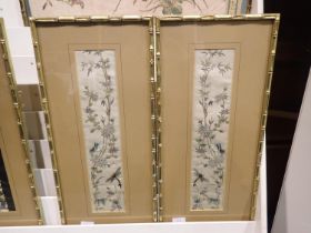 Pair of early 20th century embroidered silk panels within bamboo style frames, each 28 x 60 cm.