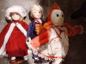 Two porcelain faced dolls and a rag doll. Not available for in-house P&P