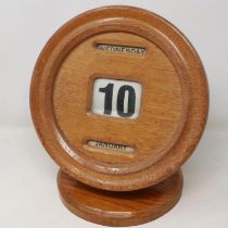 Golden oak cased perpetual calendar with day, date and month, appears to be in working order, H: