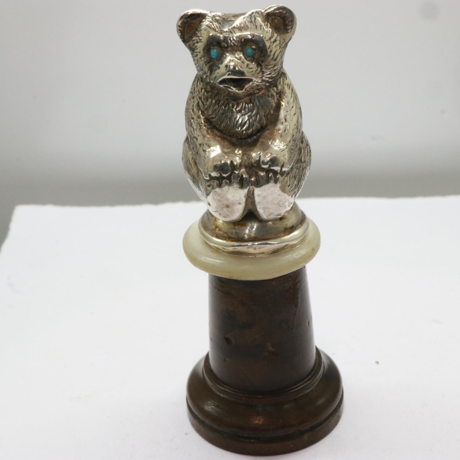 Edwardian hallmarked silver teddy bear figurine, set with turquoise eyes and mounted on a turned