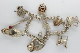 Silver charm bracelet with padlock clasp and nine charms, L: 18 cm. UK P&P Group 0 (£6+VAT for the
