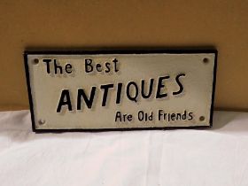 Cast iron The Best Antiques Are Old Friends sign. W: 25 cm. UK P&P Group 1 (£16+VAT for the first