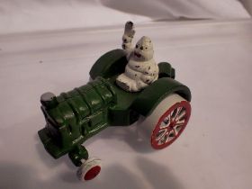 Cast iron Michelin Man on a tractor, H: 80 mm. UK P&P Group 1 (£16+VAT for the first lot and £2+