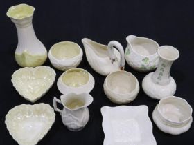 Twelve pieces of Belleek pottery including vases, no cracks or chips, largest H: 17 cm. Not