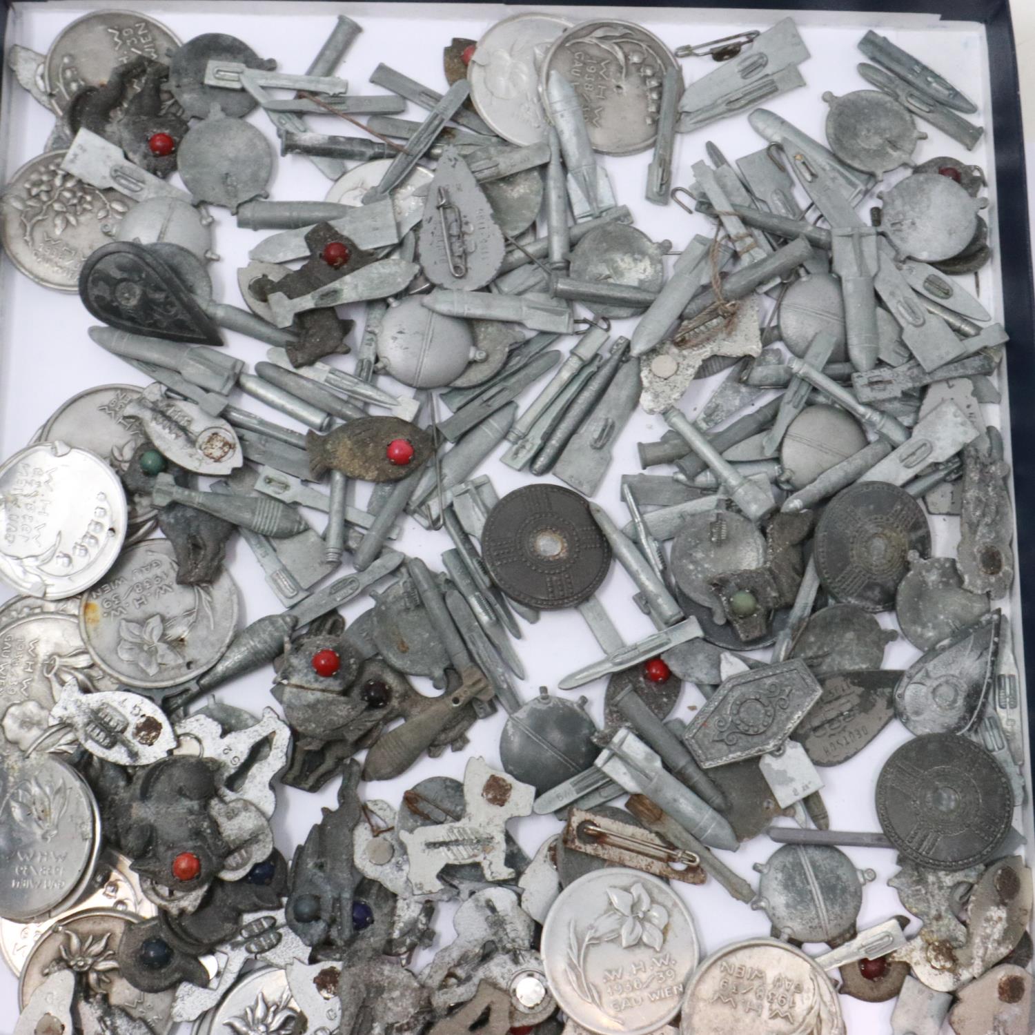 Over 200 Third Reich Winterhilf fund-raising badges, all have either pins or stones missing etc.