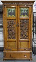 A rare Art-Nouveau period English oak two door wardrobe, in the manner of Gillows or Liberty. Each