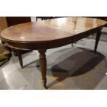 A late 19th century mahogany extending dining table, with two additional leaves, reeded supports and