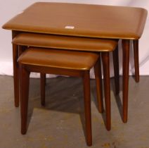 An Ercol nest of three graduating elm tables. Largest with repaired leg.