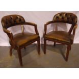 A pair of 20th century brown leather Chesterfield desk chairs.