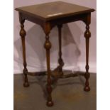 A 19th century inlaid lamp table with bent stretchers on turned supports with shaped stretchers,