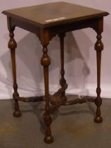 A 19th century inlaid lamp table with bent stretchers on turned supports with shaped stretchers,