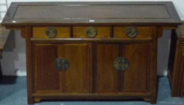 A 20th century hardwood sideboard in the Oriental manner, having three short drawers above two