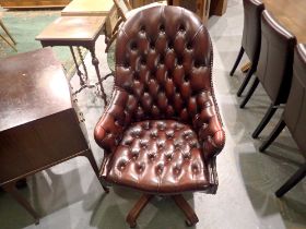 Modern red leather swivel desk chair in the chesterfield style on five star base.