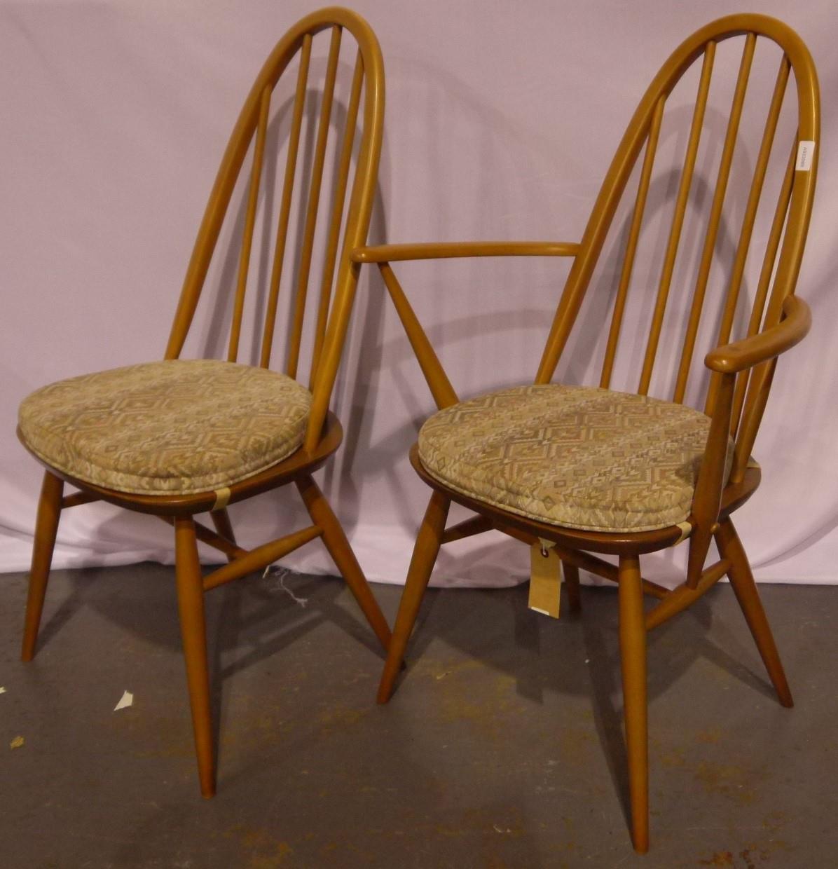 A set of six (4+2) Ercol Windsor stick-back dining chairs with upholstered seat cushions.