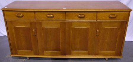 Priory of Manchester elm sideboard, of four drawers and two bi-fold cupboard doors, raised on