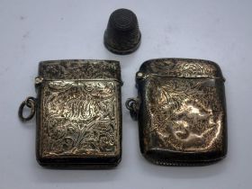 Two hallmarked silver vesta cases, Birmingham assay, and a hallmarked silver thimble, combined