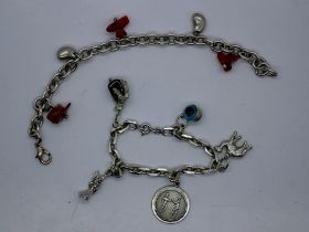 Two silver charm bracelets, largest L: 18 cm. UK P&P Group 0 (£6+VAT for the first lot and £1+VAT