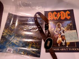 Two AC/DC concert programmes, a concert ticket from 1982, and two pieces of merchandise. UK P&P