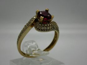 9ct gold ruby solitaire ring, crossover design with diamond set shoulders, size P, 2.7g, ruby D: 6