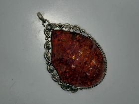 Oversized silver mounted carved and polished Baltic amber pendant, L: 90 mm, 60g. UK P&P Group 0 (£